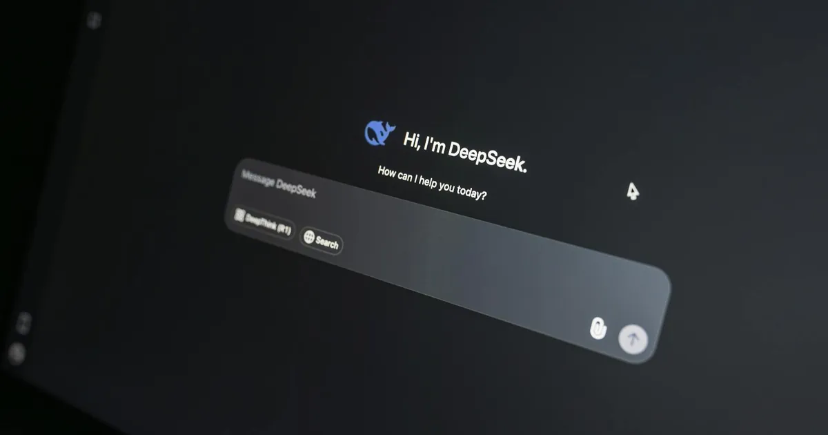 Close-up of DeepSeek AI chat interface on a laptop screen in low light.