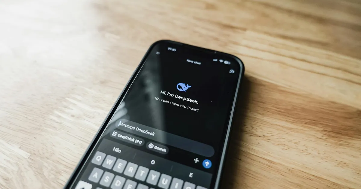 A smartphone displaying an AI chat interface, DeepSeek, on a wooden table.