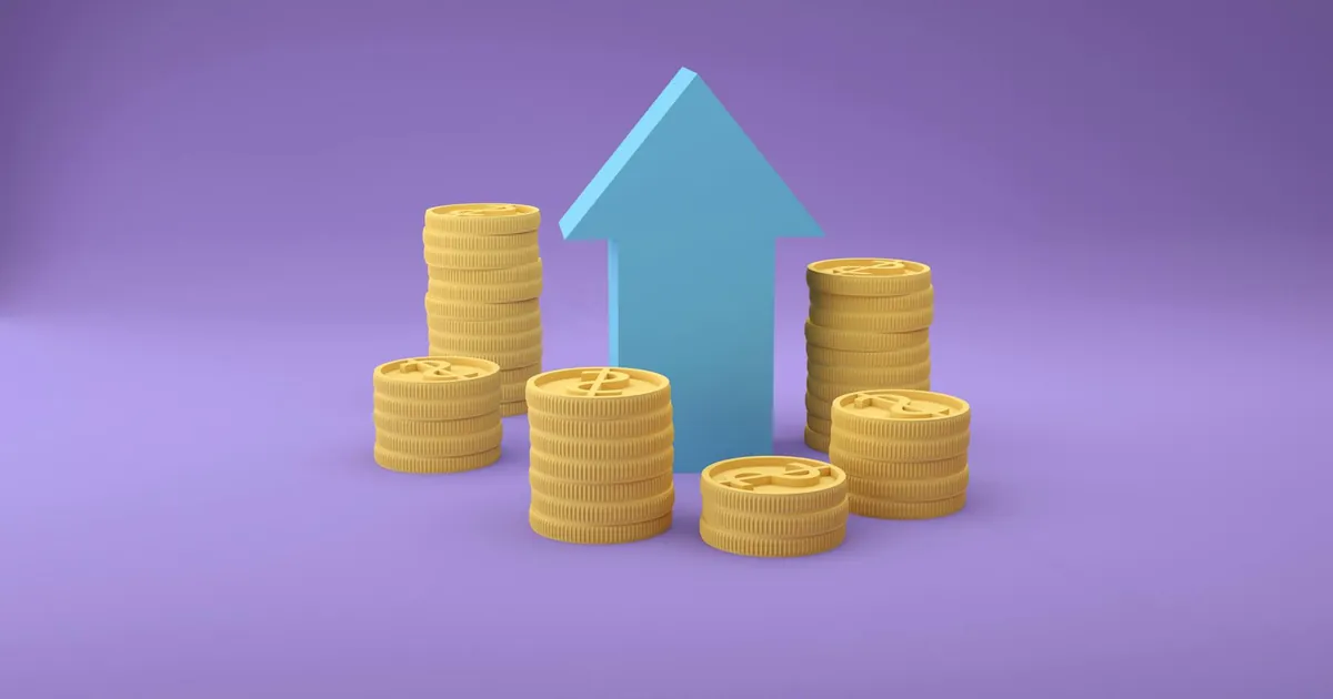 Stacks of coins with an upward arrow symbolizing financial growth and success.
