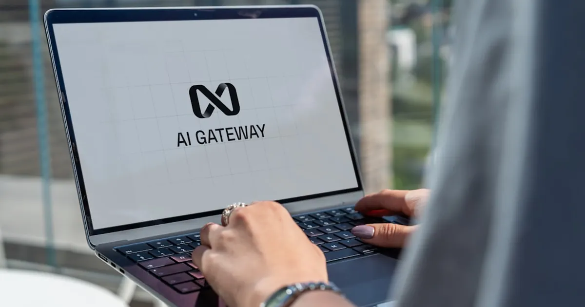 Person typing on laptop with ai gateway logo.