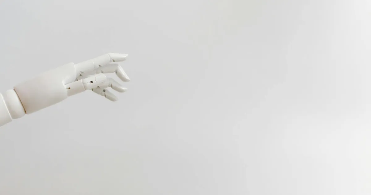 Minimalist image of a robotic hand reaching out on a white background.