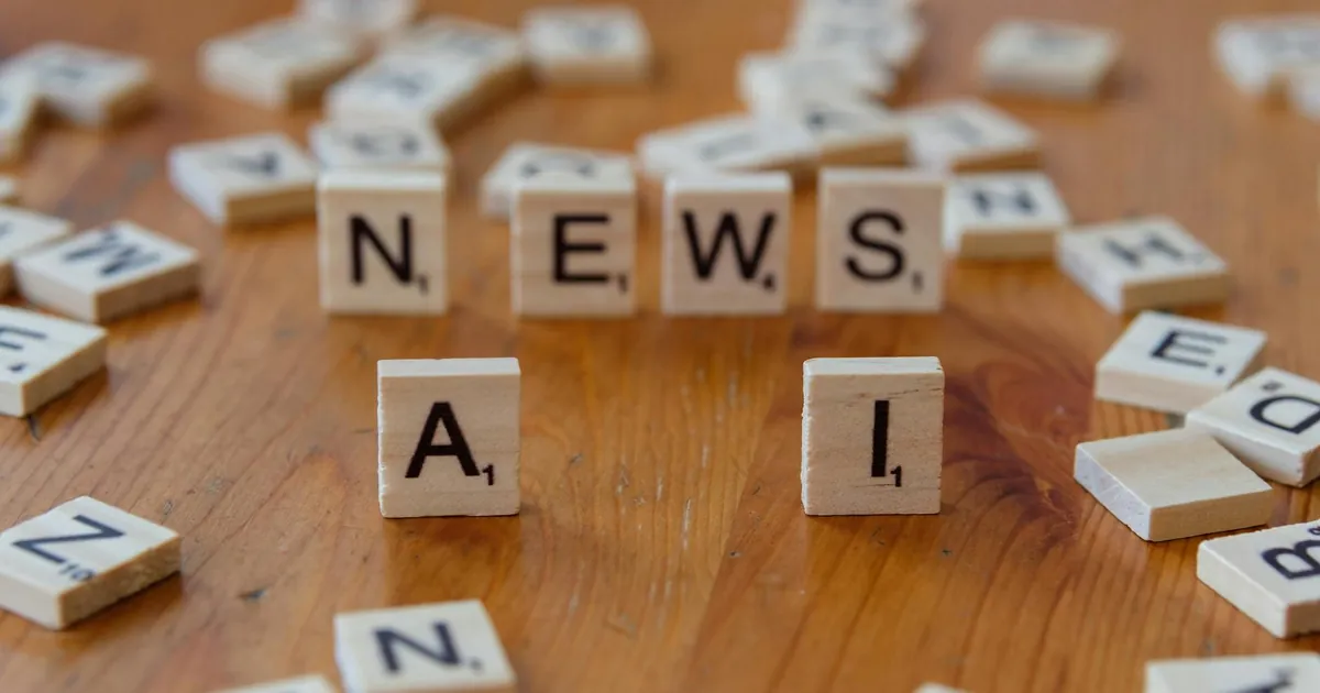 Wooden Scrabble tiles spelling 'AI' and 'NEWS' for a tech concept image.