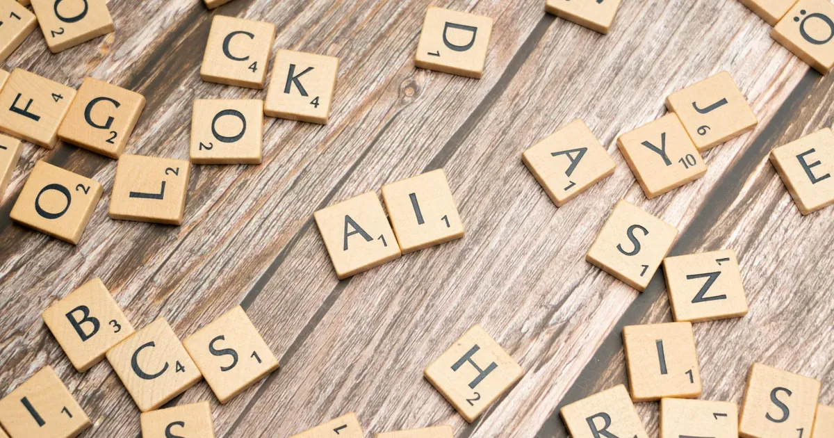 Wooden letter tiles scattered on a textured surface, spelling 'AI'.