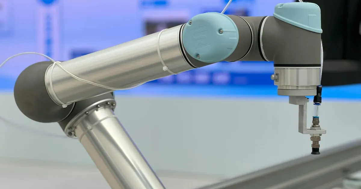 Detailed close-up of a modern industrial robotic arm in a manufacturing setting.